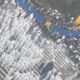 A hoard of white suited security officers stand opposite a large crowd of protesters on a dirty city street.